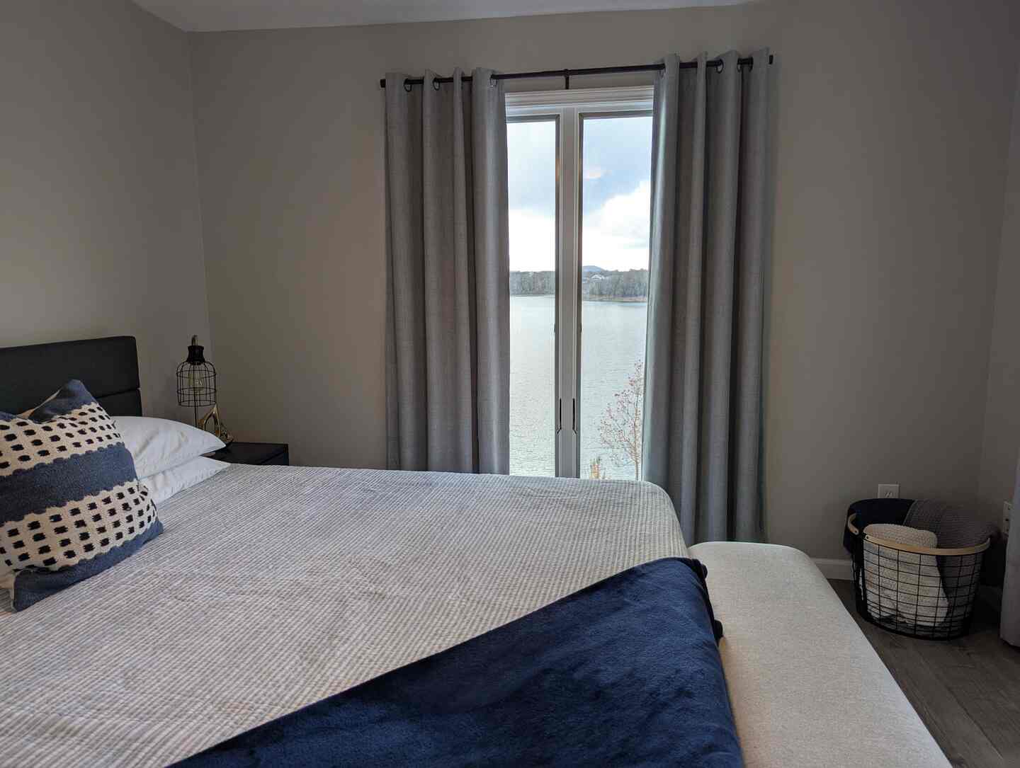 King bedroom at dusk with balcony door overlooking Table Rock Lake