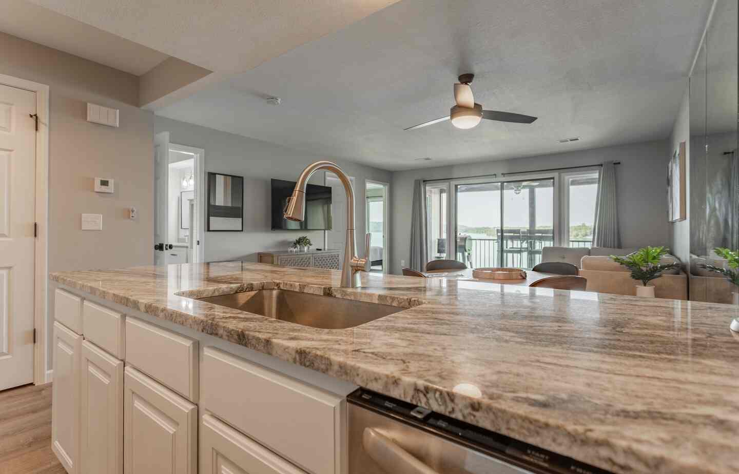 Kitchen sink with view into the living room and lake beyond